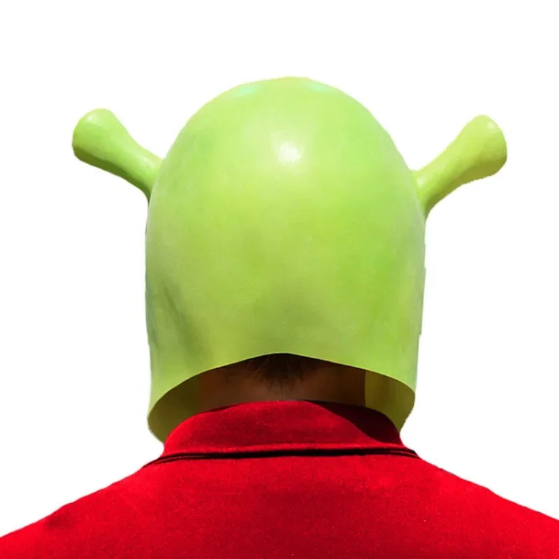 Back view of a person wearing a green, ogre-themed helmet with ear extensions, set against a white background. The person is dressed in a red shirt.