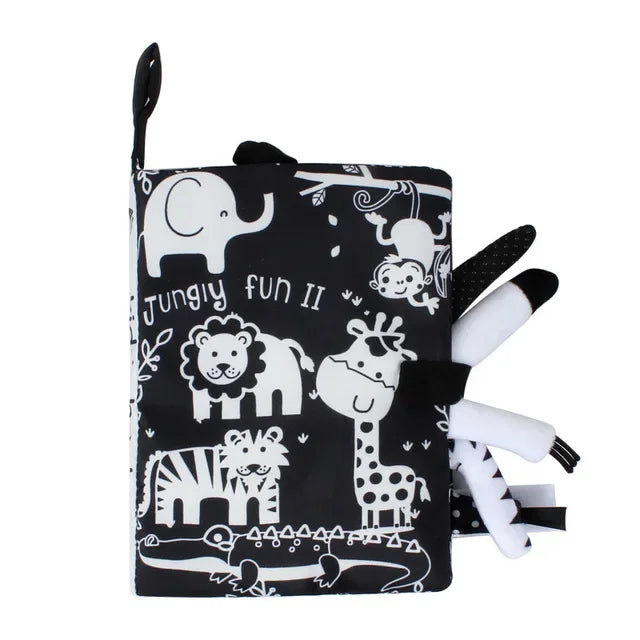 Black and white soft baby book titled "Jungly Fun II" featuring cute animal illustrations: elephant, lion, monkey, zebra, giraffe, and crocodile with textured tails and ears.