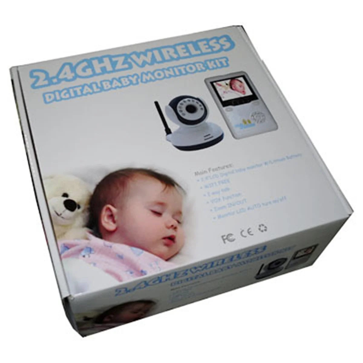 Box for a 2.4GHz wireless digital baby monitor kit shows a sleeping baby with a teddy bear. Includes a camera and monitor with features listed, like VOX function and zoom.