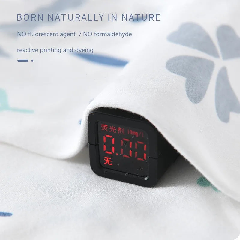 White fabric with blue and green patterns covers a digital meter reading 0.00. Text above reads, "Born naturally in nature, no fluorescent agent, no formaldehyde."