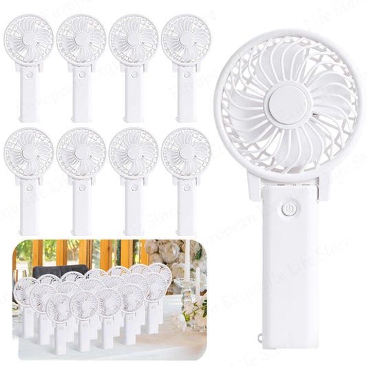 A collection of white handheld battery-operated fans with circular blades are displayed. A close-up of one fan is prominent, and a group of fans is shown on a table setting.