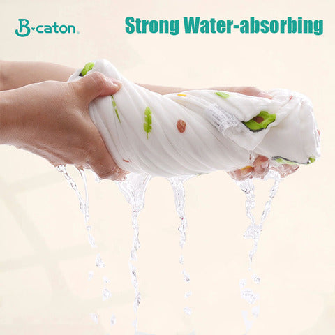 Hands wringing out a wet, printed fabric, showcasing its strong water-absorbing ability with water streaming down. Text: "Strong Water-absorbing" and "B-caton" logo in the corner.