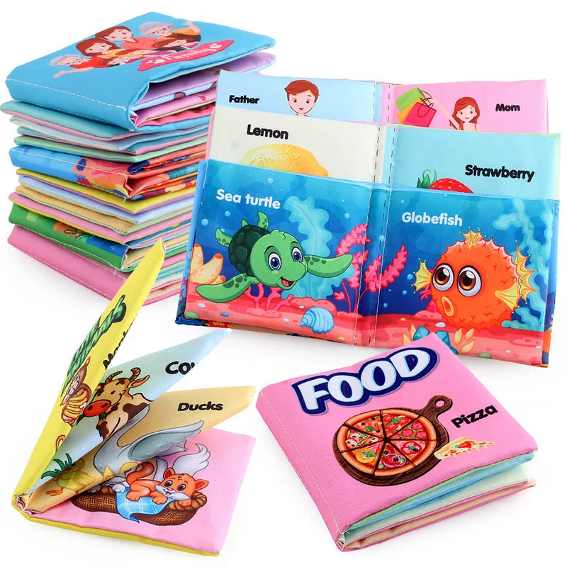 Colorful soft fabric books for children, stacked and open, depicting animals, fruits, and food items like sea turtles, strawberries, and pizza with vibrant illustrations.