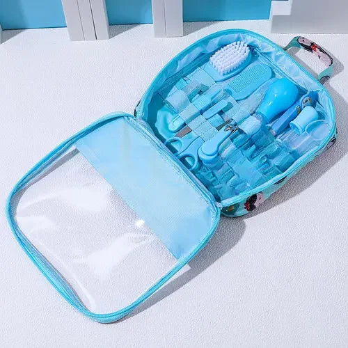 A blue portable baby grooming kit with various tools, including a brush, nail clippers, and a nasal aspirator, neatly arranged inside a transparent, zippered case.