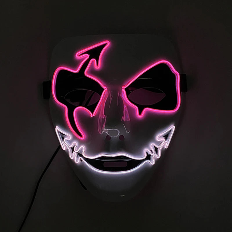 A white mask with glowing neon outlines. Pink lights highlight devil horns and eyes, while white lights form a jagged, mischievous smile. The mask is set against a dark background.