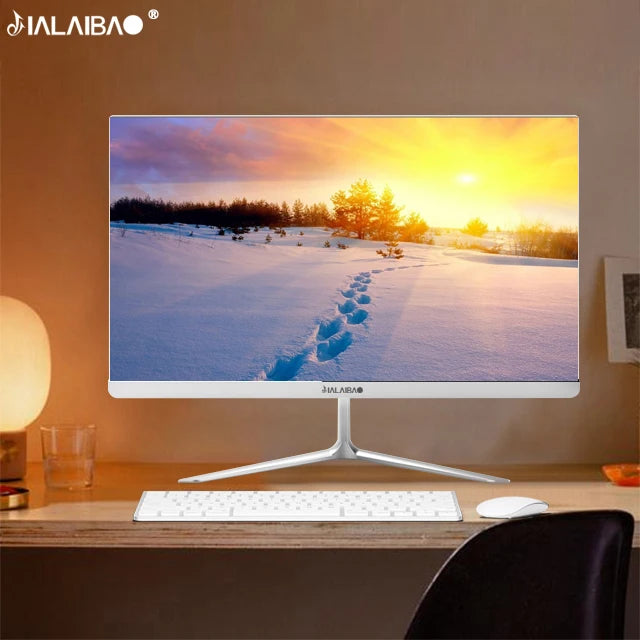 A sleek desktop computer displays a winter landscape with a sunset and snow trails. The setup includes a keyboard and mouse on a wooden desk with soft ambient lighting.