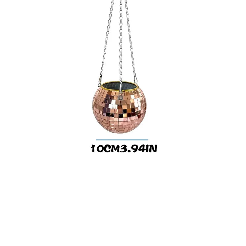 Hanging mirrored disco ball planter with a 10 cm (3.94 inches) diameter, featuring a reflective, rose-gold mosaic pattern on its surface, attached to chains for suspension.