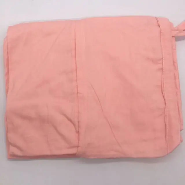 Folded light pink fabric with a subtle tie on one side placed on a white background. The fabric has a soft texture with visible creases and stitching along the edges.