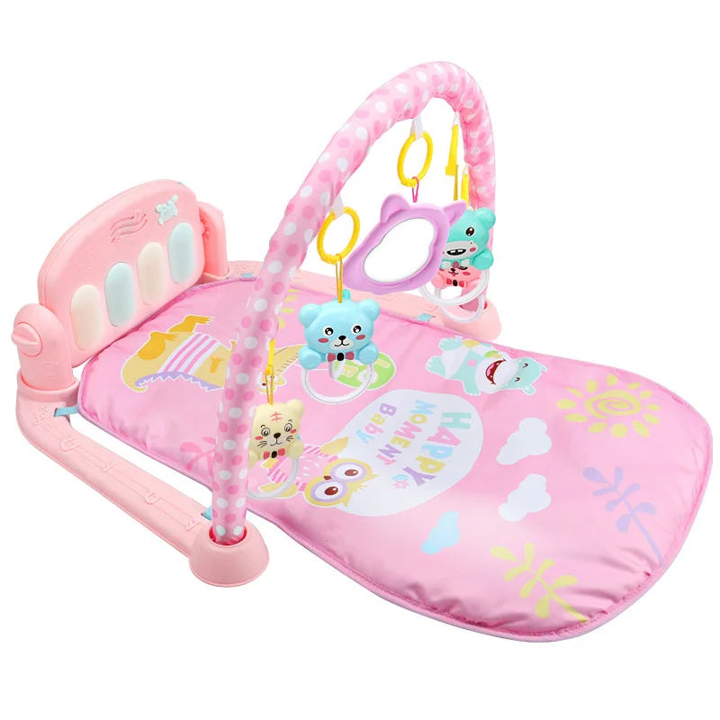 A pink baby play mat with a padded backrest and hanging plush toys, including bears and a panda, under a pink arch. The mat features colorful designs and text: "HAPPY MOMENT BABY".