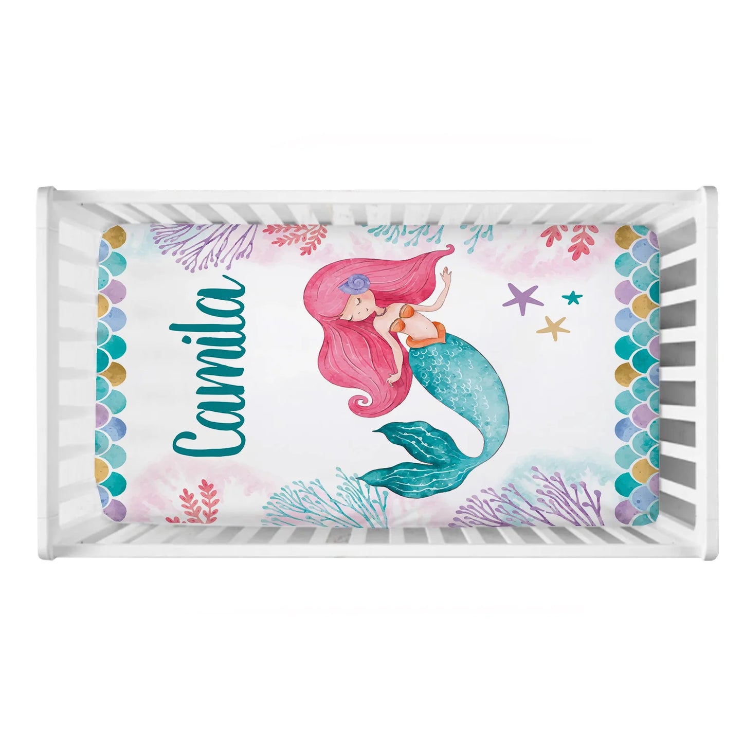 Crib mattress with a mermaid illustration, surrounded by colorful ocean elements and scales. The name "Camila" is written in aqua blue on the left.