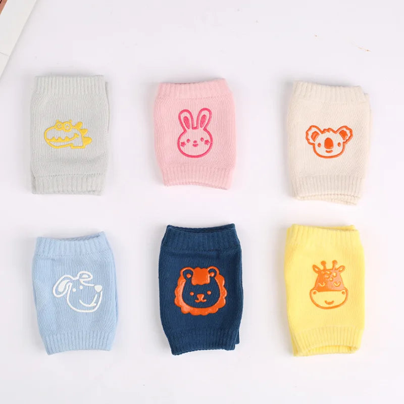 Six pairs of colorful children's socks with animal designs: a yellow dinosaur, pink rabbit, beige koala, blue dog, navy lion, and yellow giraffe, arranged neatly on a white background.