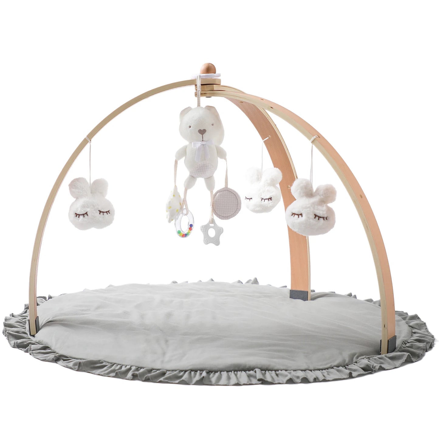 A baby play gym with a soft gray mat, wooden arches, and hanging plush toys including a white bear and sleeping cloud figures. Ideal for infant play and sensory development.