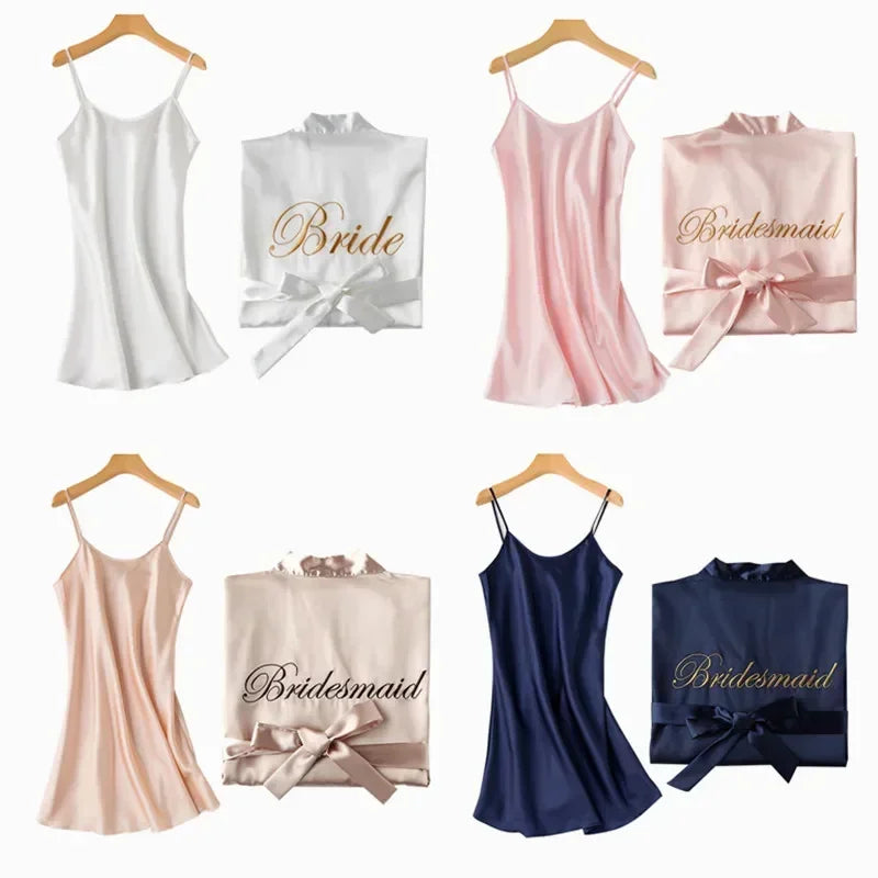Wedding-themed satin robes and dresses on hangers, featuring "Bride" in white, and "Bridesmaid" in pink, beige, and navy, with matching folded robes tied with ribbons.
