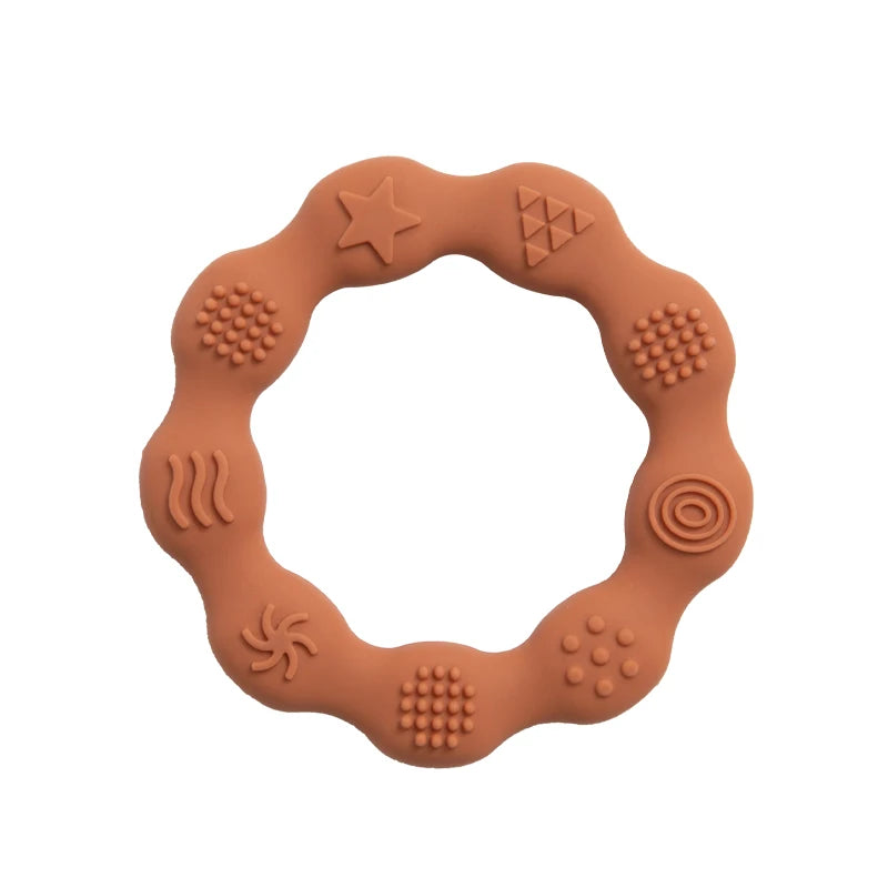 Brown, wavy silicone teething ring with various raised textures and shapes, including a star, spirals, and dots, designed for sensory stimulation and chewing.