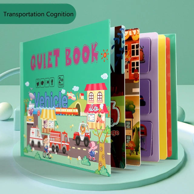 Children's quiet book titled "Vehicle" with colorful illustrations of vehicles and buildings. The book pages are open, displaying vibrant, engaging images for kids aged 2+.