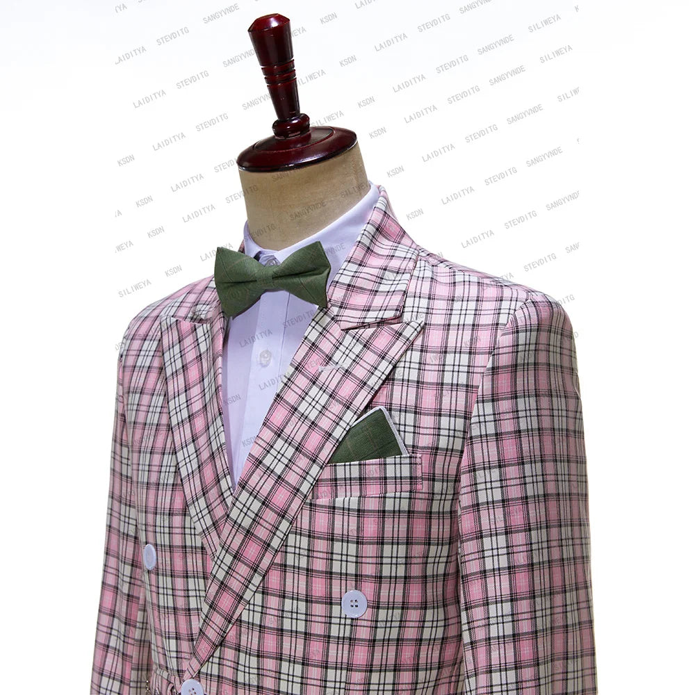A mannequin displays a stylish ensemble featuring a pink and black plaid double-breasted suit with white buttons, paired with a green bow tie and pocket square over a white shirt.