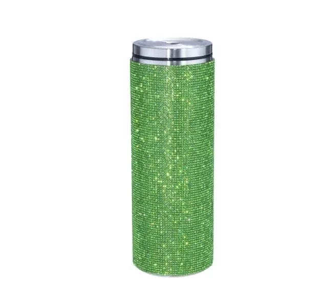 Tall cylindrical tumbler covered in sparkling green rhinestones with a shiny silver lid, isolated on a white background.
