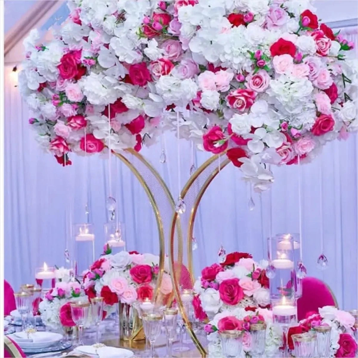 Elegant table setting with lavish pink and white floral centerpiece, surrounded by candles and glassware on a royal dining table, creating a luxurious event ambiance.