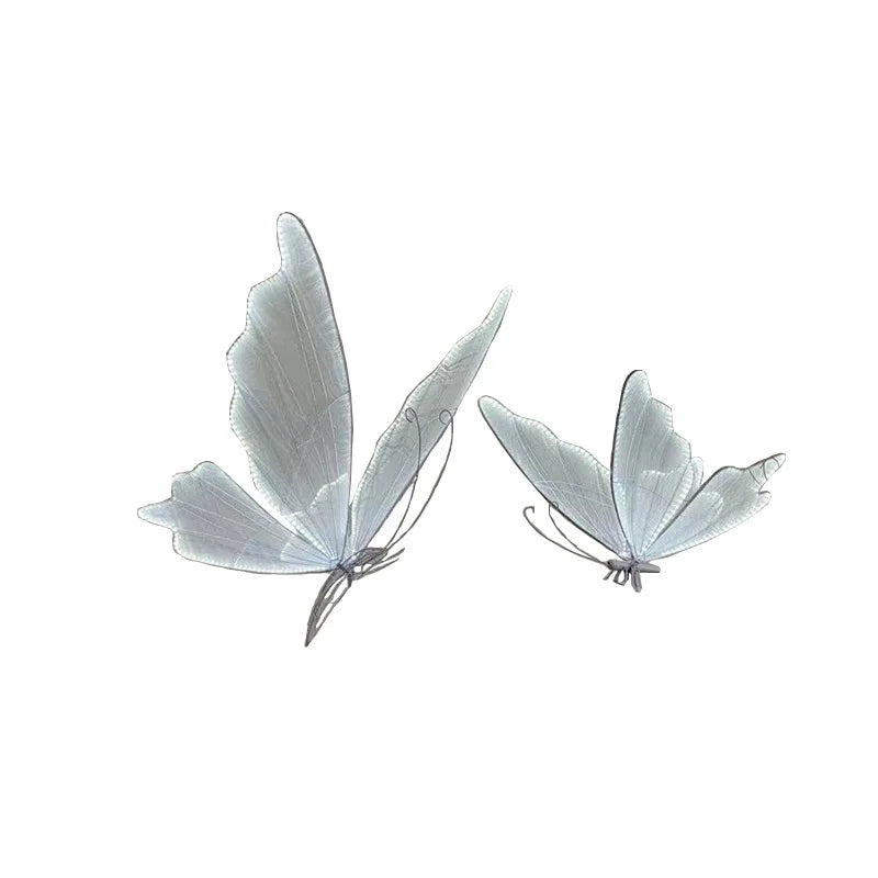 Two delicate, white translucent butterflies with intricate wings are shown against a plain white background, highlighting their graceful, ethereal appearance.