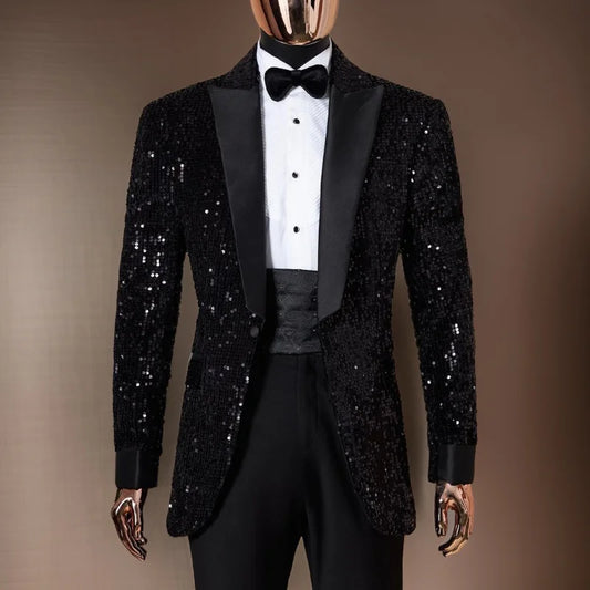 Mannequin wearing a black sequined tuxedo with satin lapels, a white dress shirt, black bow tie, and matching trousers, set against a simple brown background.