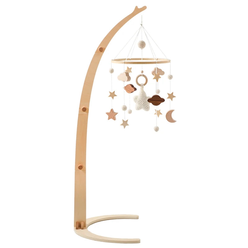 Wooden baby mobile with a curved stand, featuring hanging stars, clouds, and a moon in neutral tones. Perfect for nursery decor.