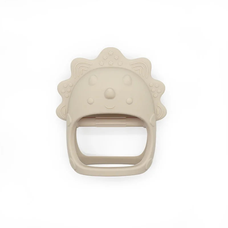 Beige silicone lion-shaped teether with textured mane and smiley face, designed for infants to grip and chew.