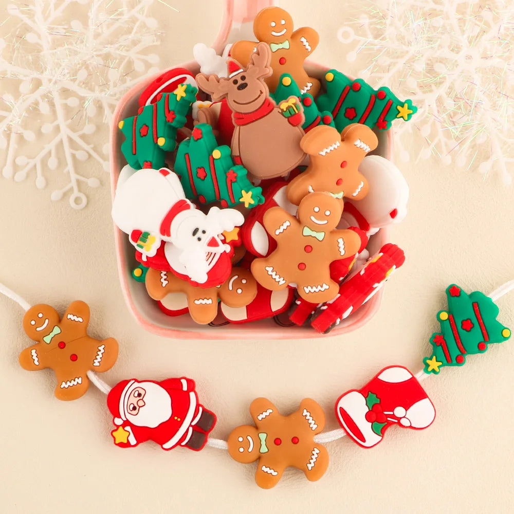 Bowl filled with Christmas-themed rubber charms: gingerbread men, trees, Santa, reindeer. Garland below features similar festive shapes against a light background.