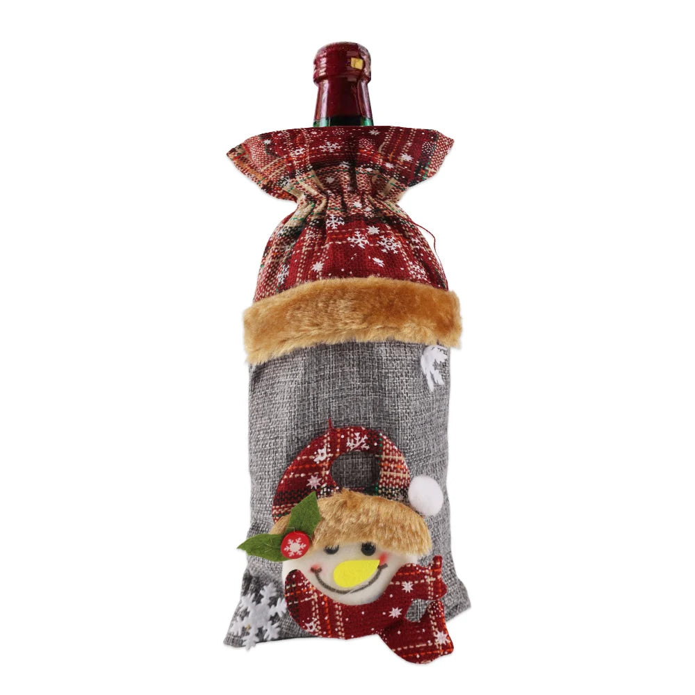 Festive wine bottle cover featuring a plaid top and snowman design. Red, green, and gray colors with a fur trim, creating a cheerful winter holiday appearance.