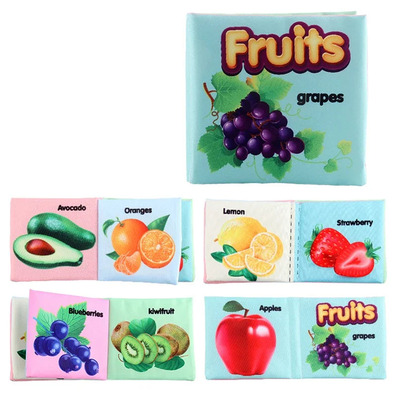 Soft fabric book titled "Fruits" with grape illustration on the cover. Inside pages display images and names of various fruits, including avocado, orange, lemon, strawberry, blueberry, and apple.