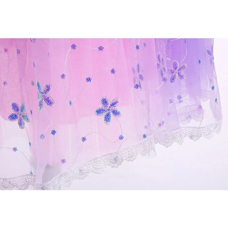 Pink and purple ombre fabric with intricate beadwork in blue floral patterns, accented by silver lace trim at the hem.