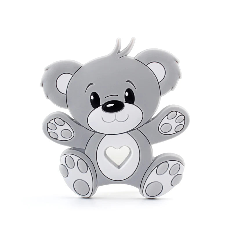 Cartoon-style gray koala with big eyes and a smiling face. It has a heart-shaped cutout on its belly and sits with arms and legs spread wide, showing the paw pads.