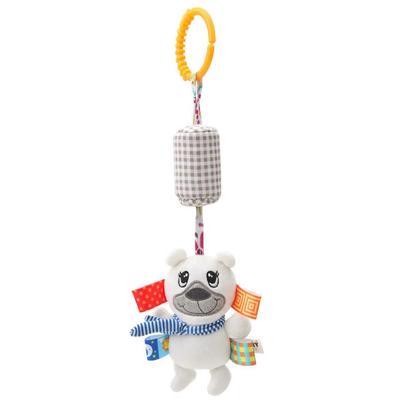 A hanging plush toy featuring a smiling bear with a blue striped scarf and colorful fabric tags. It includes a checkered cylinder and a yellow ring for attachment to cribs or strollers.