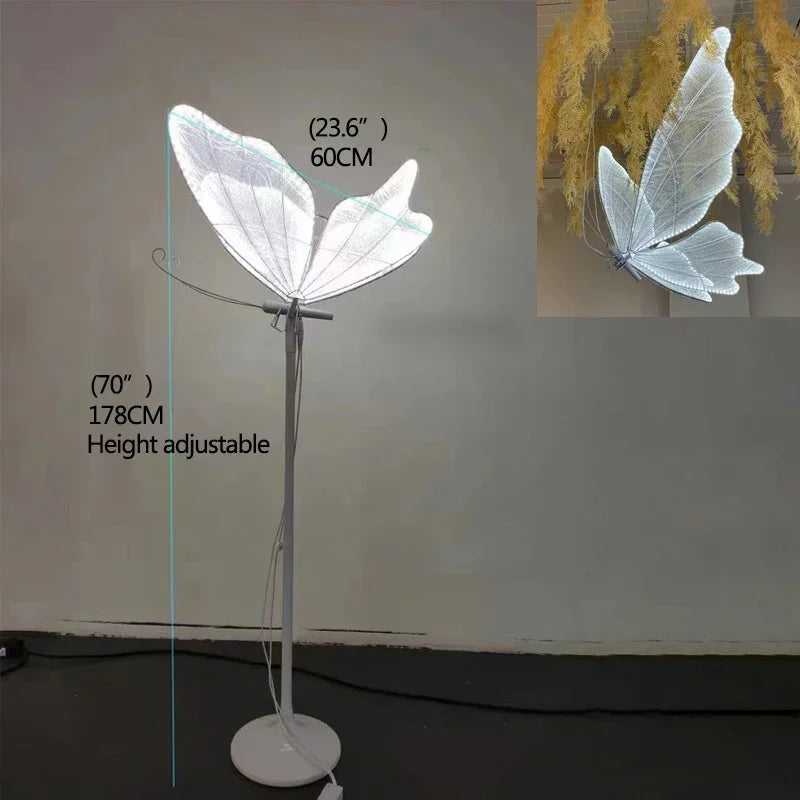 Height-adjustable floor lamp resembling butterfly wings, 70 inches tall and 23.6 inches wide, with soft glowing light and detailed fabric design. Inset shows wings from another angle.