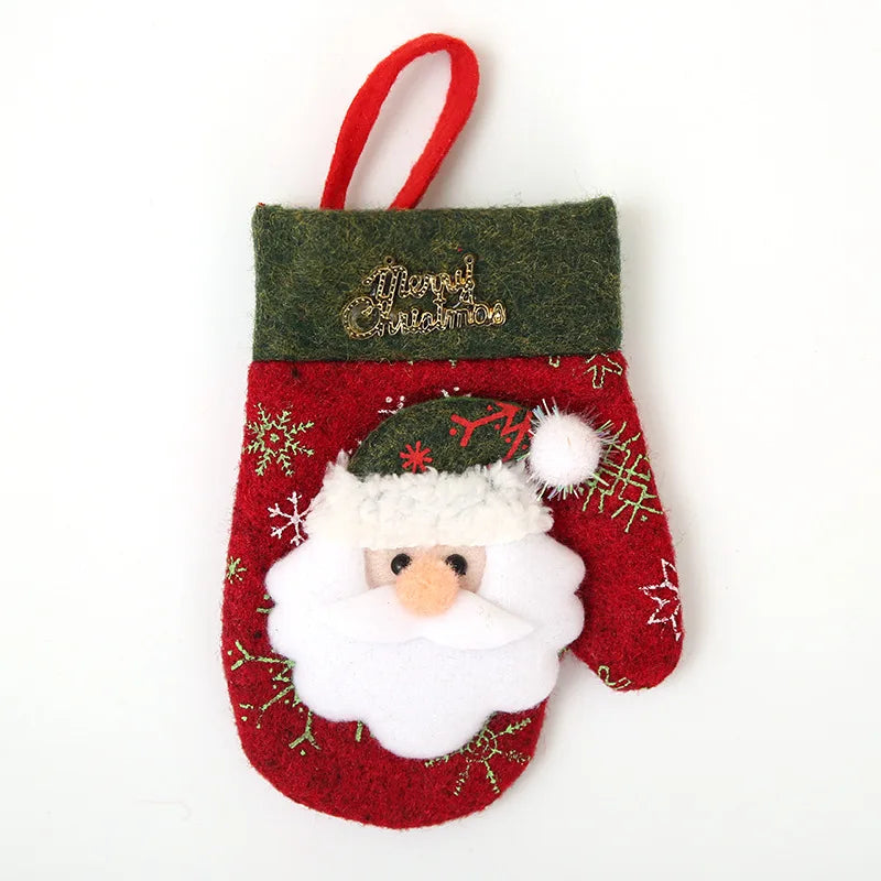 Red Christmas mitten with Santa face design, green trim, and gold "Merry Christmas" text. Decorated with snowflakes and holly patterns, has a red hanging loop.
