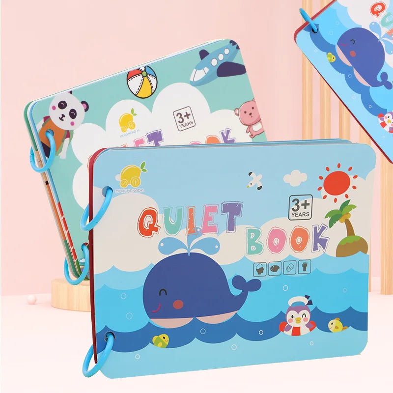 Colorful children's quiet book cover with playful illustrations featuring a smiling blue whale, sun, palm tree, and playful characters, suitable for ages 3 and up.