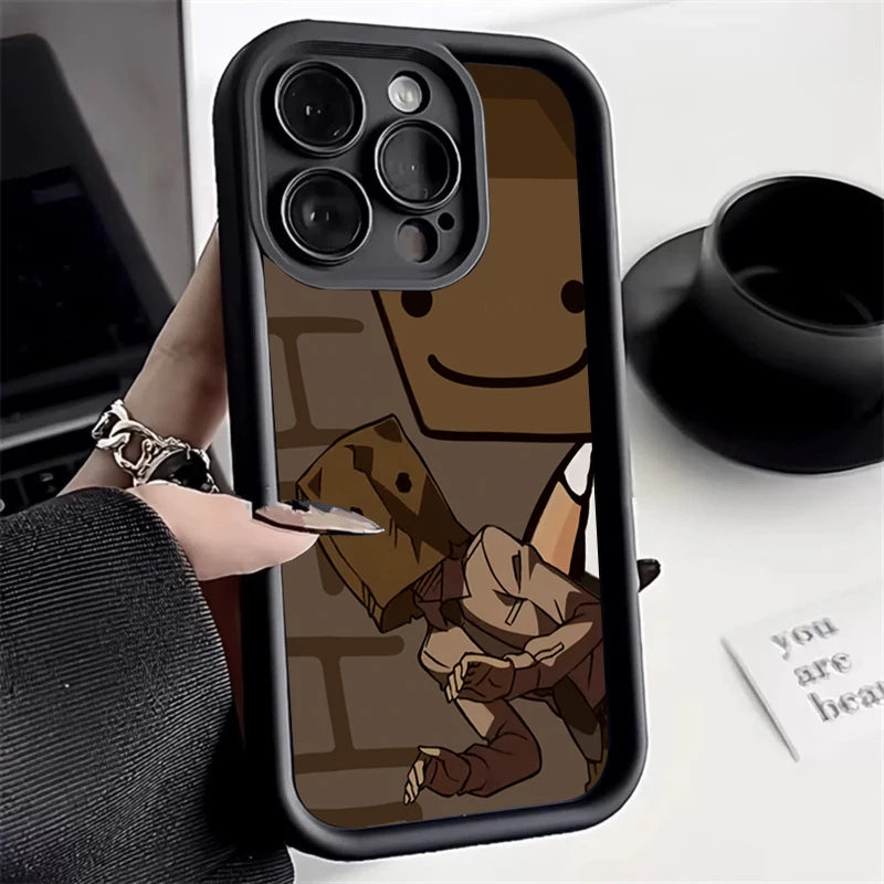Close-up of a smartphone case with a cartoon character wearing a paper bag over their head. The character is in a playful pose with a large, smiling character in the background.