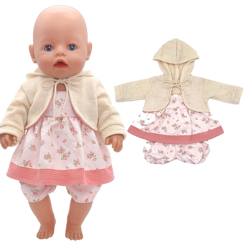 A baby doll wears a beige hooded jacket and a pink floral dress with matching bloomers. The outfit is also shown separately on the right.