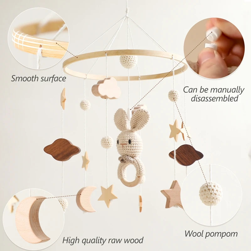 Wooden baby mobile with stars, clouds, a bunny, and wool pompoms. Features include a smooth surface, manual disassembly, and high-quality raw wood construction.