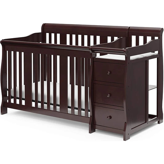 Dark wood crib with an attached changer, featuring three drawers and a safety rail. The crib has vertical slats and a mattress, combining functionality and elegant design.