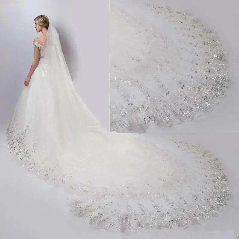 A bride in an elegant white gown with off-shoulder sleeves and a long, intricately beaded train, featuring a close-up of the shimmering details on the train.