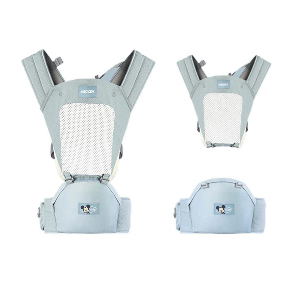 Light blue baby carrier with Mickey Mouse logo on the front. It features wide padded shoulder straps and a breathable mesh panel. Two views are shown: full carrier and detachable seat.