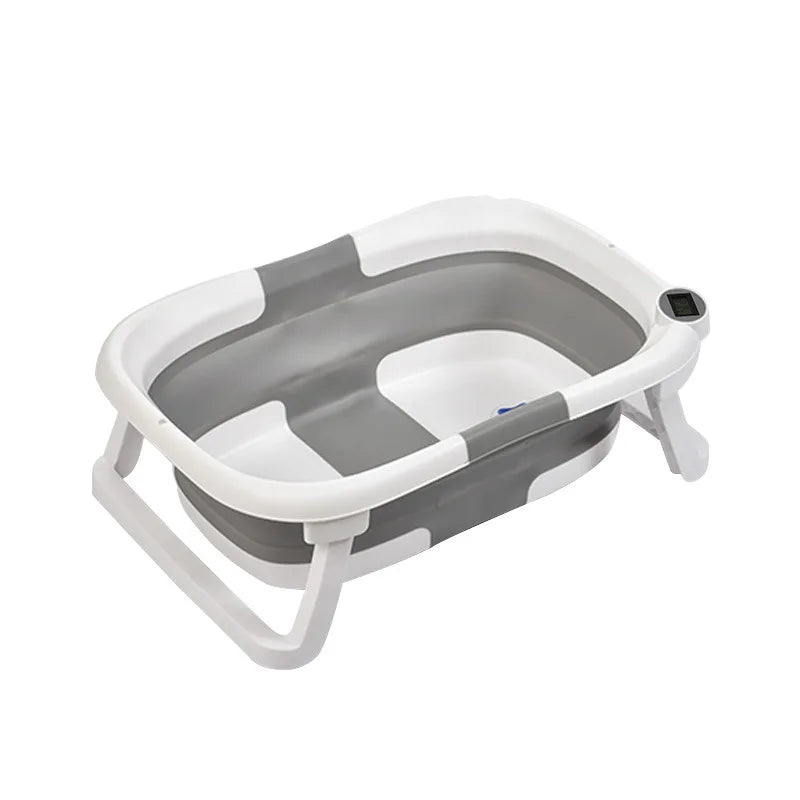 Collapsible grey and white baby bathtub with ergonomic design. Features foldable legs and integrated digital thermometer for easy temperature monitoring.
