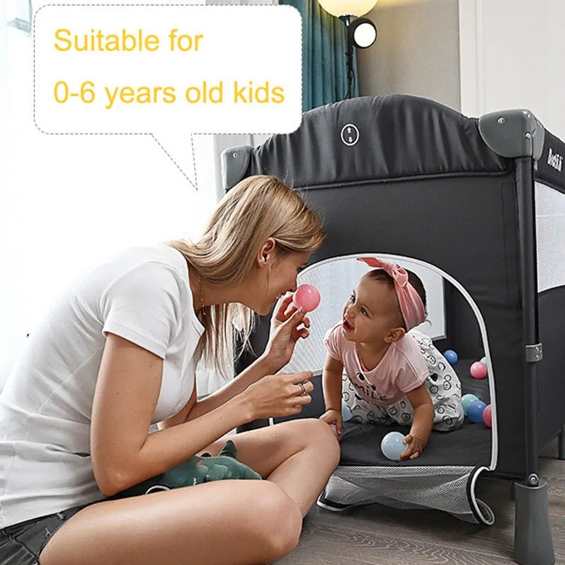 A woman plays with a baby holding a pink ball inside a black and gray playpen, surrounded by colorful balls. A text bubble reads, "Suitable for 0-6 years old kids."