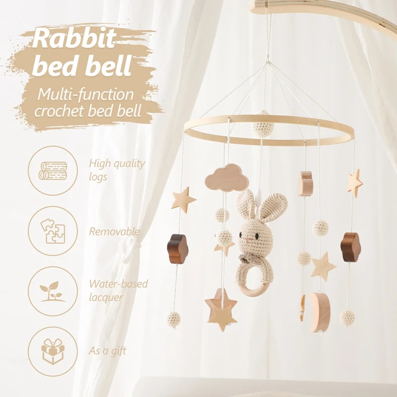 Crochet rabbit baby mobile with wooden stars and shapes, hanging from a hoop. Features include high-quality logs, removability, water-based lacquer, and is ideal as a gift.