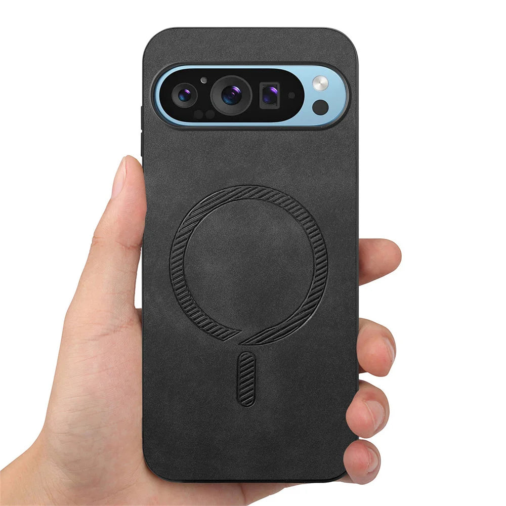 Hand holding a black smartphone with a triple-lens camera on a blue oval plate. The phone case features a circular indented design in the center.