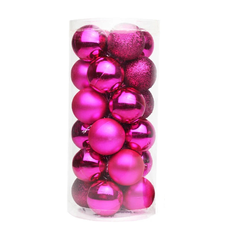 A clear plastic container filled with shiny and matte pink Christmas baubles, including some with glittery textures.