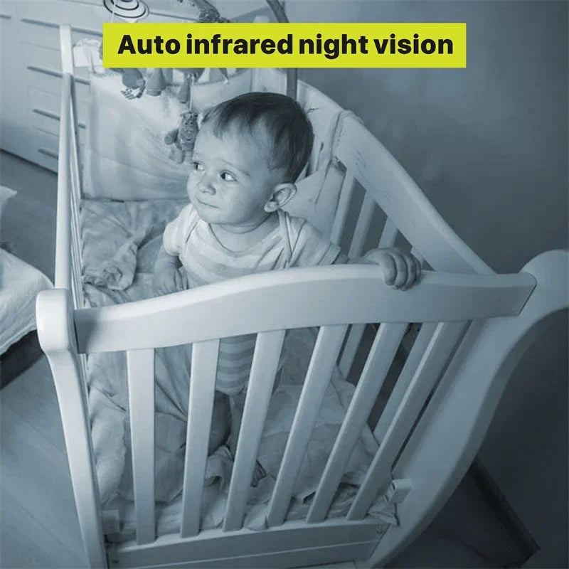Baby standing in a crib captured by auto infrared night vision. The room is dimly lit, highlighting the crib's details and the baby's curious expression. Text: "Auto infrared night vision."