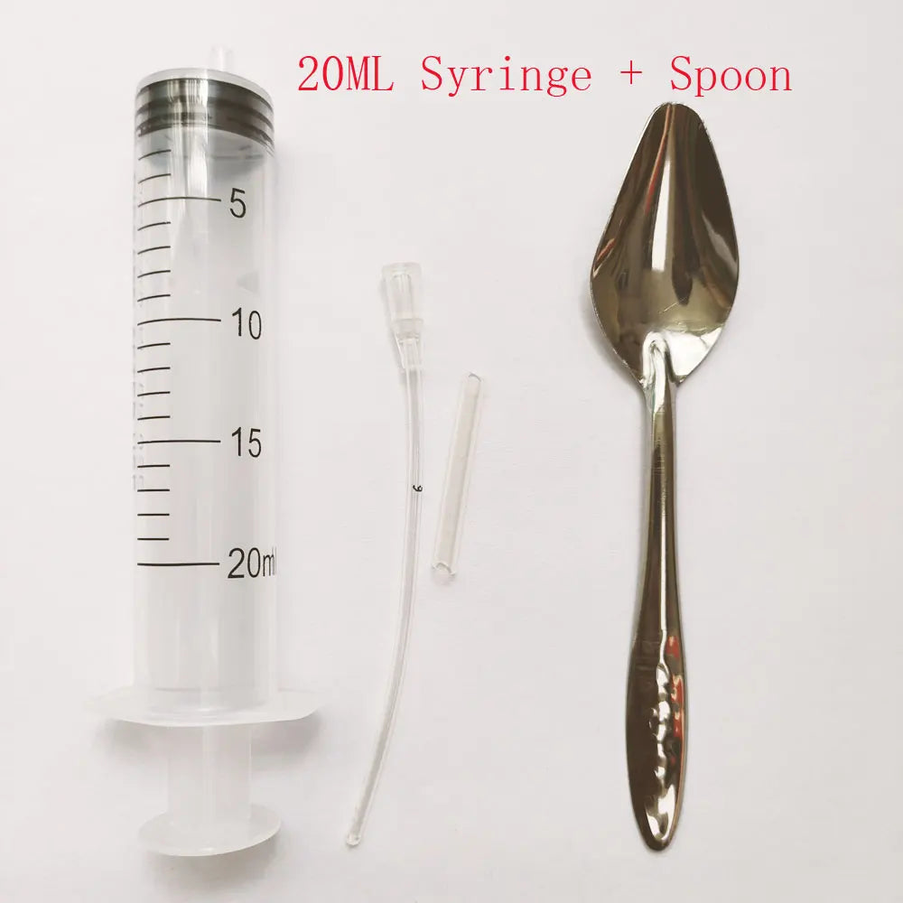 20ml syringe with measurement markings on the left, a flexible tube and connector in the center, and a reflective metal spoon on the right, labeled "20ML Syringe + Spoon" above.