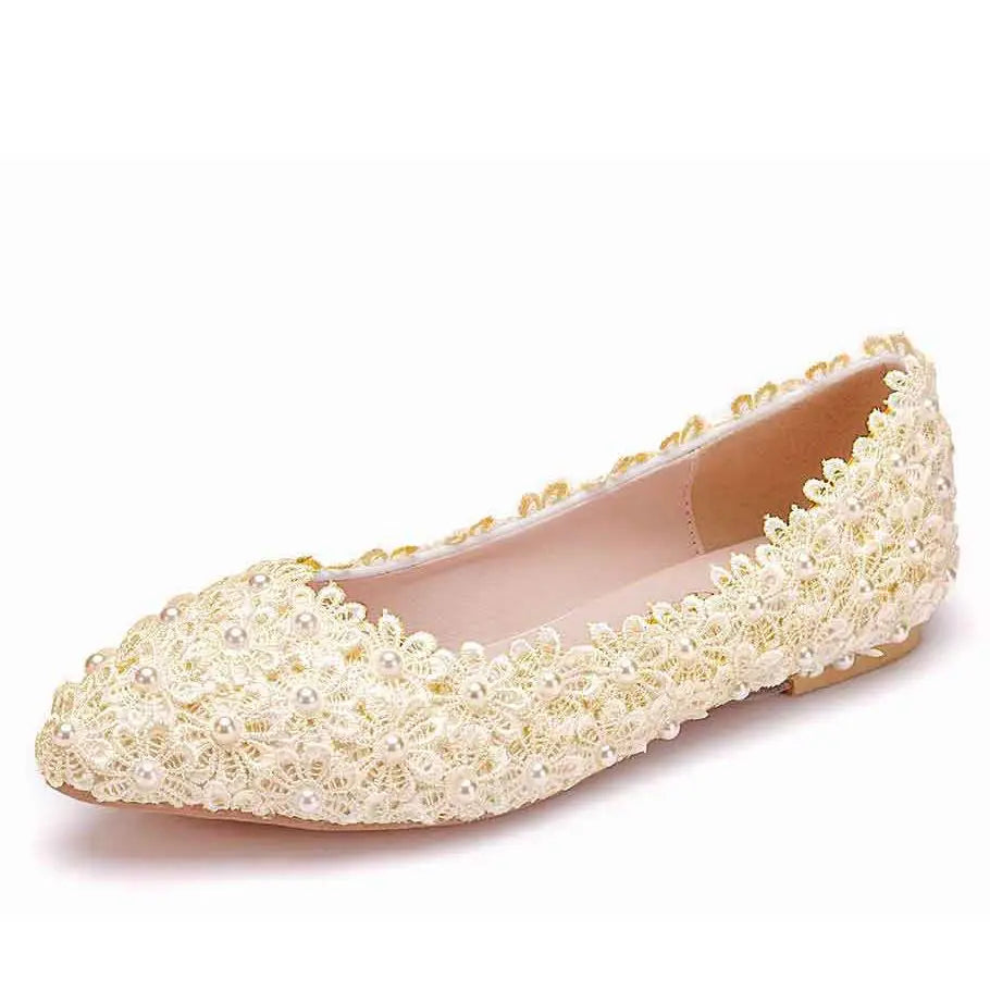 Elegant cream flat shoe adorned with intricate floral lace and pearl details, featuring a rounded toe and light-colored sole, perfect for formal occasions.