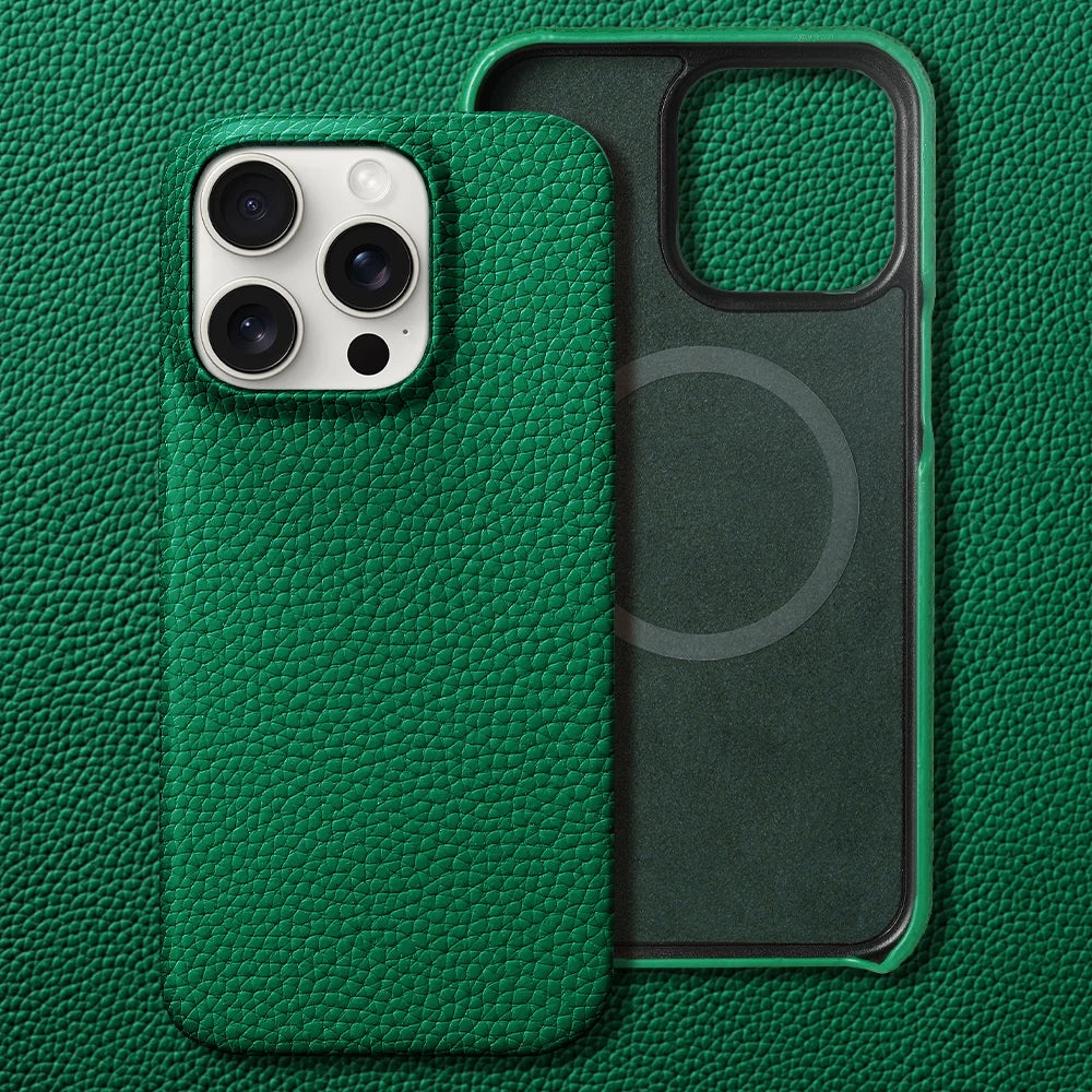Green leather-textured phone case with a visible camera cutout, placed on a matching leather surface. The inner side shows a circular pattern.